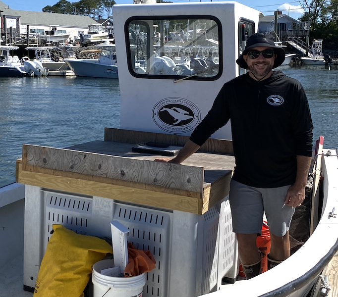 Center for Coastal Studies Owen Nichols standing aboard the CFCS work boat